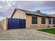 Home exterior featuring a privacy gate, gravel landscaping, and ample windows at 502 N 110Th St, Mesa, AZ 85207