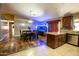 Open concept kitchen features stainless steel appliances, dark wood cabinetry, and an adjacent dining area at 502 N 110Th St, Mesa, AZ 85207