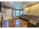 The living room features wood laminate floors, a brown leather couch, and a mounted TV at 502 N 110Th St, Mesa, AZ 85207