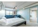 Bright bedroom with light blue walls, comfortable bed and sofas at 535 W Thomas Rd # 211, Phoenix, AZ 85013