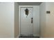 Close up of a front door featuring unit number and festive wreath hanging, creating a welcoming entrance at 535 W Thomas Rd # 211, Phoenix, AZ 85013
