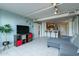 Open-concept living room with tile flooring, a modern kitchen view, and cozy furniture creating a vibrant living space at 535 W Thomas Rd # 211, Phoenix, AZ 85013
