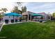 Expansive backyard features green lawn, pool area, outdoor kitchen and covered dining at 59 W Cypress St, Phoenix, AZ 85003