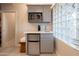 Bar area with a mini-fridge, microwave, sink, and a textured glass window at 59 W Cypress St, Phoenix, AZ 85003