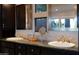Bathroom featuring dual sinks with granite countertops, dark wood cabinets, and modern fixtures at 59 W Cypress St, Phoenix, AZ 85003