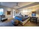 Spacious bedroom with tufted headboard, ceiling fan, an upholstered bench, and recessed lighting at 59 W Cypress St, Phoenix, AZ 85003
