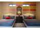Bedroom showcases two beds, an antique dresser, and colorful wall details at 59 W Cypress St, Phoenix, AZ 85003