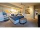 Bright bedroom featuring a ceiling fan, neutral walls, upholstered bench, and a tufted headboard at 59 W Cypress St, Phoenix, AZ 85003