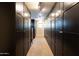 Spacious walk-in closet with custom dark wood cabinetry and ample storage space at 59 W Cypress St, Phoenix, AZ 85003