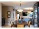 Dining room with an elegant chandelier and view of living room with TV at 59 W Cypress St, Phoenix, AZ 85003
