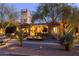 Beautiful home showcasing desert landscaping, warm exterior lighting, and mature trees at twilight at 59 W Cypress St, Phoenix, AZ 85003