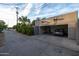 Detached garage features brick-paved driveway with parking and mature bushes along alley at 59 W Cypress St, Phoenix, AZ 85003