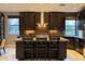 Modern kitchen island with dark cabinetry, granite countertops, and stainless steel appliances at 59 W Cypress St, Phoenix, AZ 85003