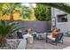 Trendy outdoor living space with comfortable seating, a fire pit, and tropical plants at 59 W Cypress St, Phoenix, AZ 85003