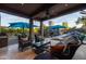 Covered patio features an outdoor kitchen, a lounge area, and a view of the refreshing pool at 59 W Cypress St, Phoenix, AZ 85003