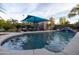 Resort-style backyard oasis featuring a sparkling pool, rock waterfall, and shaded lounge area at 59 W Cypress St, Phoenix, AZ 85003