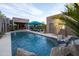 Gorgeous pool features a waterfall, palm trees, lounge seating, and meticulous landscaping at 59 W Cypress St, Phoenix, AZ 85003