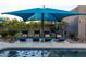 Stunning backyard pool with an umbrella and chairs and well manicured landscaping at 59 W Cypress St, Phoenix, AZ 85003