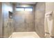 Modern tiled shower with a rainfall shower head, niche, and a window for natural light at 59 W Cypress St, Phoenix, AZ 85003