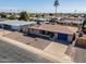 Aerial view of a single-story home featuring a gravel yard, blue garage, and palm trees at 6319 E Duncan St, Mesa, AZ 85205