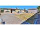 Back yard featuring a hot tub, shed, and patio; the lawn is surrounded by gravel at 6319 E Duncan St, Mesa, AZ 85205