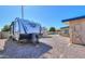 RV parked in the gravel backyard next to a shed with a hot tub and house visible at 6319 E Duncan St, Mesa, AZ 85205