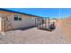 Gravel driveway and backyard next to a house with a trailer and block fence at 6319 E Duncan St, Mesa, AZ 85205