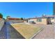 Large backyard with a hot tub, rock landscaping, block fence, and green grass area at 6319 E Duncan St, Mesa, AZ 85205