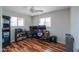 This versatile bedroom is currently set up as an office and features wood flooring and a ceiling fan at 6319 E Duncan St, Mesa, AZ 85205