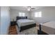 Spacious bedroom with light-colored walls, a ceiling fan, and bright windows at 6319 E Duncan St, Mesa, AZ 85205
