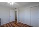 Bedroom with a large closet, wood floors, neutral walls, and a ceiling fan at 6319 E Duncan St, Mesa, AZ 85205