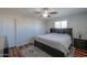 Large bedroom with dark-wood furniture, ceiling fan, and a window overlooking the yard at 6319 E Duncan St, Mesa, AZ 85205