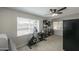 Bright bedroom with neutral walls, ceiling fan, and a view of the yard at 6319 E Duncan St, Mesa, AZ 85205