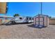 RV and storage shed are parked in the gravel driveway next to a house at 6319 E Duncan St, Mesa, AZ 85205