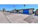 Single-story home featuring a blue garage door, gravel landscaping, and front porch at 6319 E Duncan St, Mesa, AZ 85205