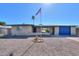 Charming single-Gathering home with desert landscaping and a blue accent garage door at 6319 E Duncan St, Mesa, AZ 85205
