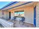 Inviting covered front porch features decorative brickwork and outdoor seating at 6319 E Duncan St, Mesa, AZ 85205