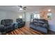 Bright living room showcasing hardwood floors and a seamless flow into the kitchen area at 6319 E Duncan St, Mesa, AZ 85205