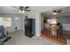 Multi-use space featuring carpet, wood flooring, ceiling fans, and a black refrigerator at 6319 E Duncan St, Mesa, AZ 85205