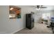 Open space featuring multi flooring, natural lighting, ceiling fan, and black refrigerator at 6319 E Duncan St, Mesa, AZ 85205