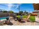 Charming backyard with a fire pit, colorful chairs, and lush greenery for outdoor enjoyment at 8519 E Rancho Vista Dr, Scottsdale, AZ 85251