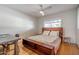 Well-lit bedroom with hardwood floors, a modern ceiling fan, and a unique wooden headboard design at 8519 E Rancho Vista Dr, Scottsdale, AZ 85251