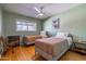 Cozy bedroom with two twin beds, a ceiling fan, and warm lighting for a restful ambiance at 8519 E Rancho Vista Dr, Scottsdale, AZ 85251