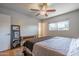 Bright bedroom with a ceiling fan, mirror, and natural light from the window creates a cozy atmosphere at 8519 E Rancho Vista Dr, Scottsdale, AZ 85251