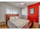 Inviting bedroom with hardwood floors, a modern ceiling fan, and a unique wooden headboard design at 8519 E Rancho Vista Dr, Scottsdale, AZ 85251