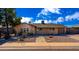 Charming single-story home with a desert landscaped front yard and brick walkway under a blue sky at 8519 E Rancho Vista Dr, Scottsdale, AZ 85251