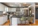 Modern kitchen with stainless steel appliances, white cabinets, and granite countertops with island seating at 8519 E Rancho Vista Dr, Scottsdale, AZ 85251