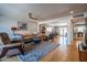 A spacious living room with hardwood floors, a ceiling fan, and an open floor plan into the dining and kitchen areas at 8519 E Rancho Vista Dr, Scottsdale, AZ 85251