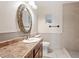 Bathroom features vanity with granite counters, a toilet, and shower at 9245 S 4Th Ave, Phoenix, AZ 85041