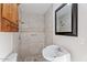 This tiled bathroom is equipped with cabinet storage, a mirror, and a sink at 9245 S 4Th Ave, Phoenix, AZ 85041